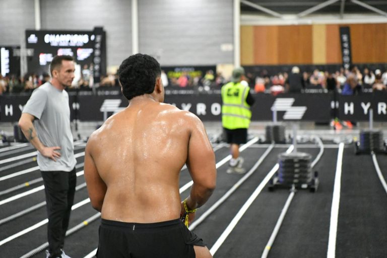 Athlete preparing for intense fitness challenge indoors at a competitive event in Singapore.